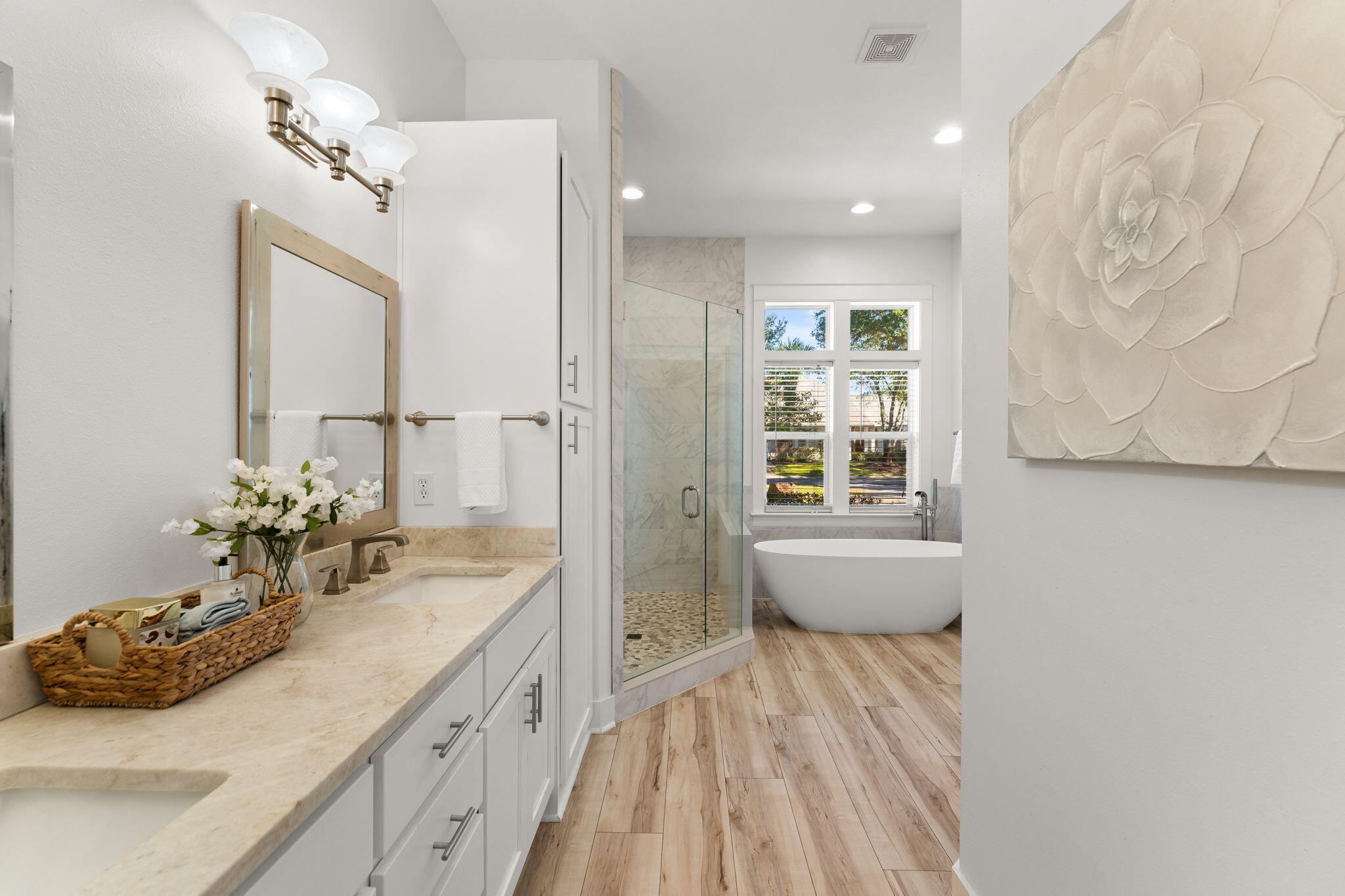 81 Botany Boulevard Santa Rosa Beach, FL 32459 - Photo 25 of 62 a spacious bathroom with a double vanity sink a large mirror a bathtub and next to a window