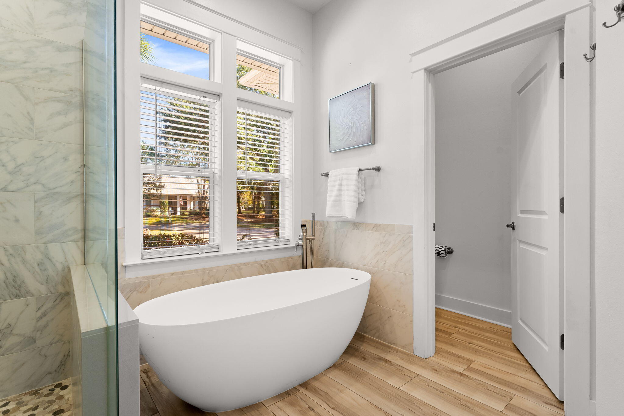 81 Botany Boulevard Santa Rosa Beach, FL 32459 - Photo 26 of 62 a white bath tub sitting in a bathroom next to a window