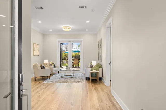 a living room with furniture and a wooden floor
