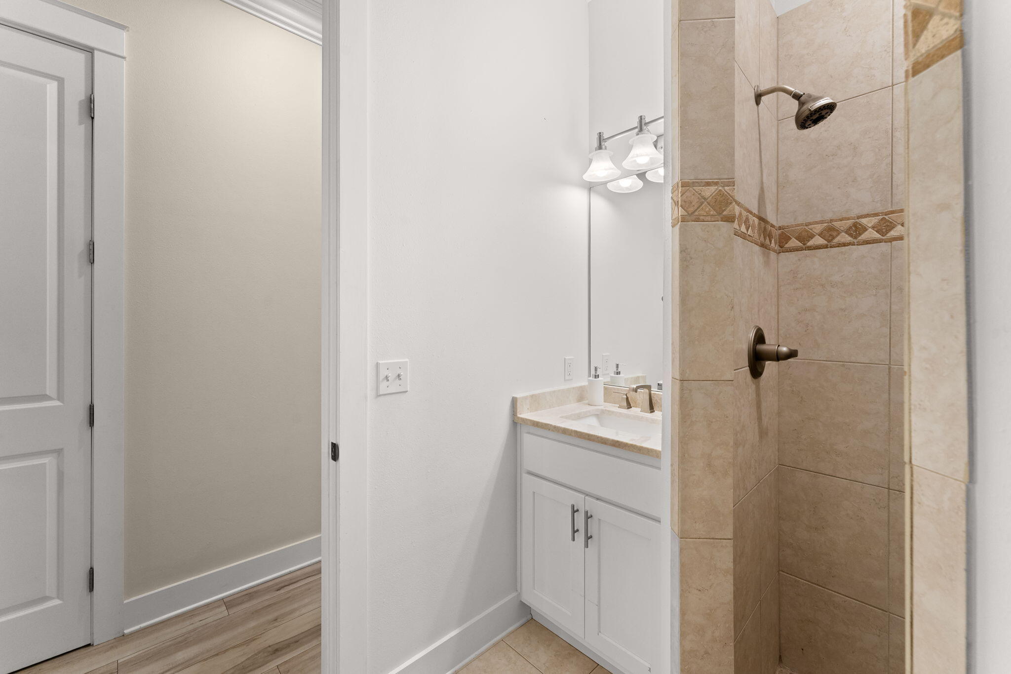 81 Botany Boulevard Santa Rosa Beach, FL 32459 - Photo 34 of 62 a bathroom with a sink a mirror and shower