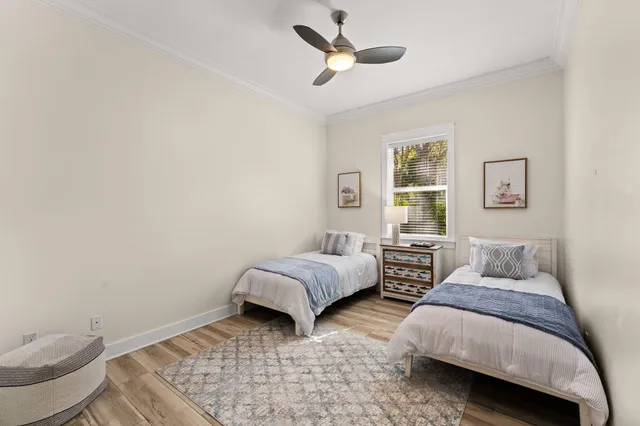 a view of a workspace with furniture window and a ceiling fan