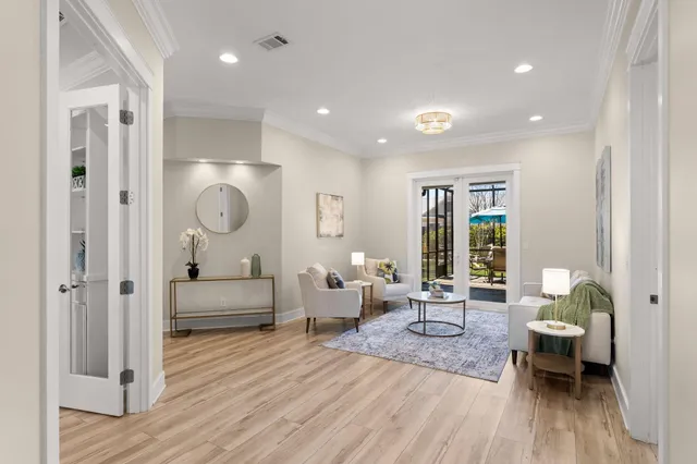 a living room with furniture and wooden floor