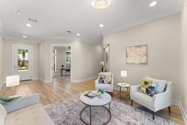 a living room with furniture and wooden floor