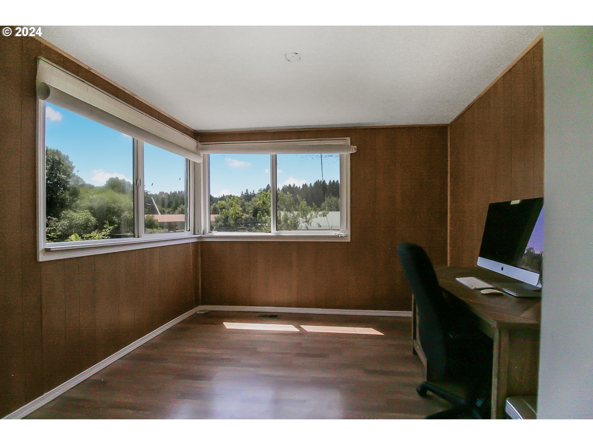 20239 Northwest Pihl Road Banks, OR 97106 - Photo 14 of 35 a view of an empty room with wooden floor and a window