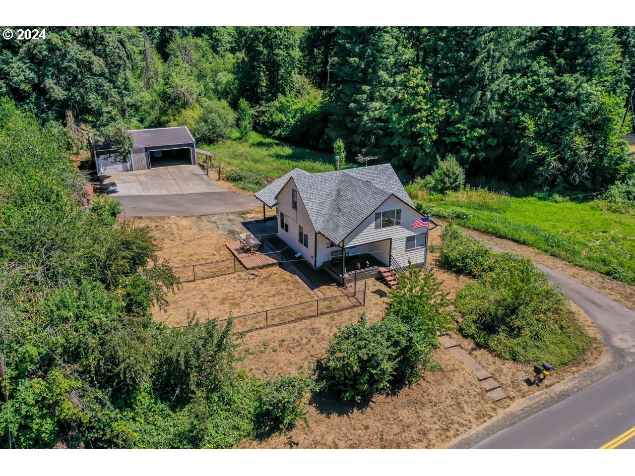 20239 Northwest Pihl Road Banks, OR 97106 - Photo 2 of 35 a view of a house with a big yard plants and large trees