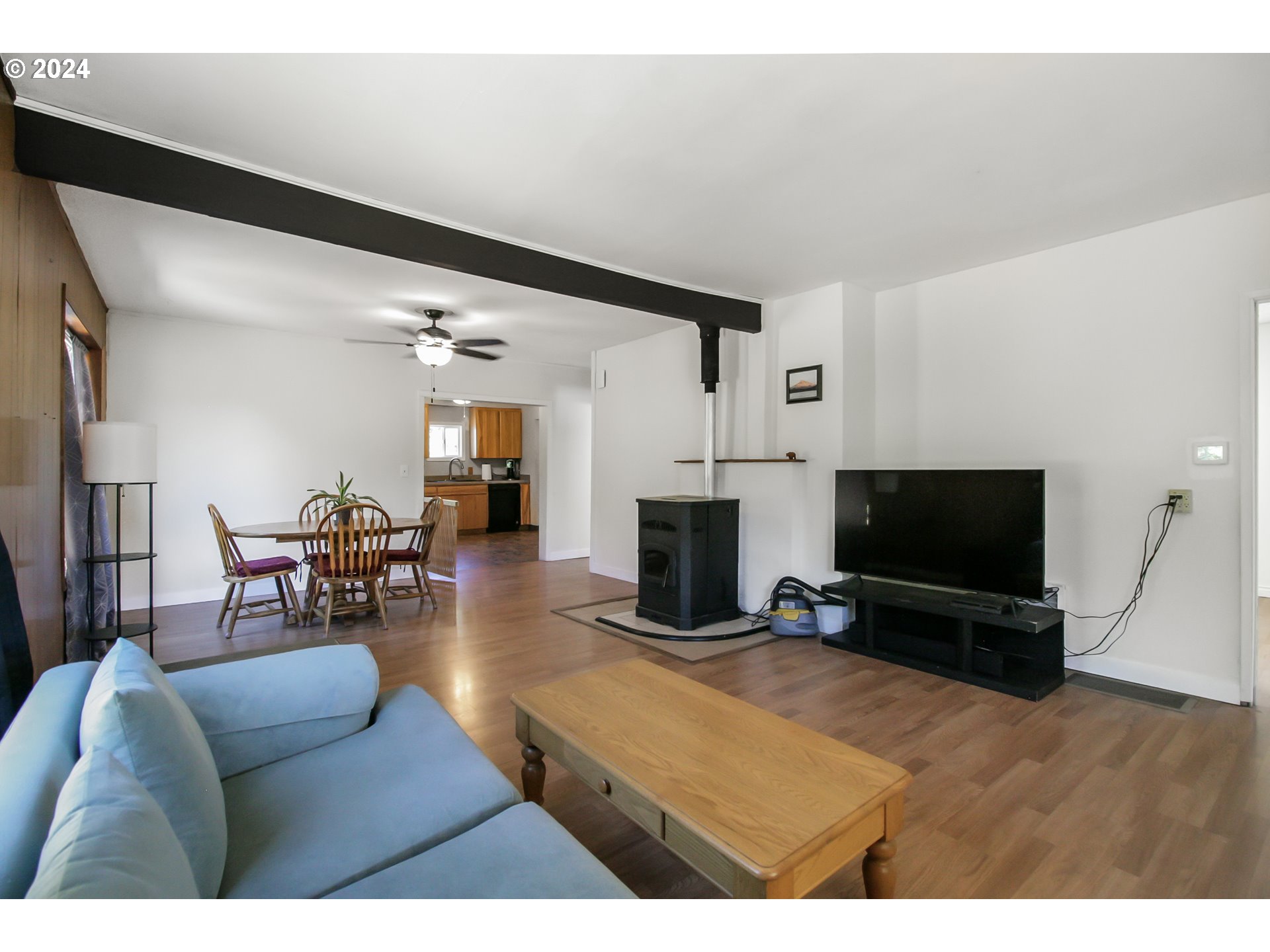 20239 Northwest Pihl Road Banks, OR 97106 - Photo 6 of 35 a living room with furniture a flat screen tv and a fireplace