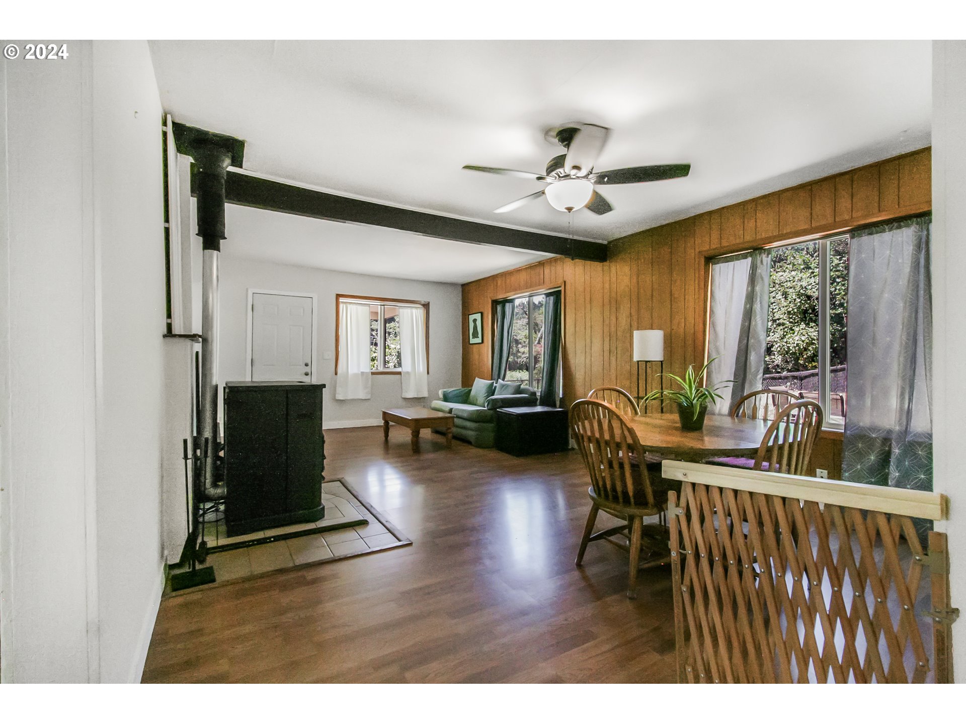 20239 Northwest Pihl Road Banks, OR 97106 - Photo 7 of 35 a living room with furniture a fireplace and a large window
