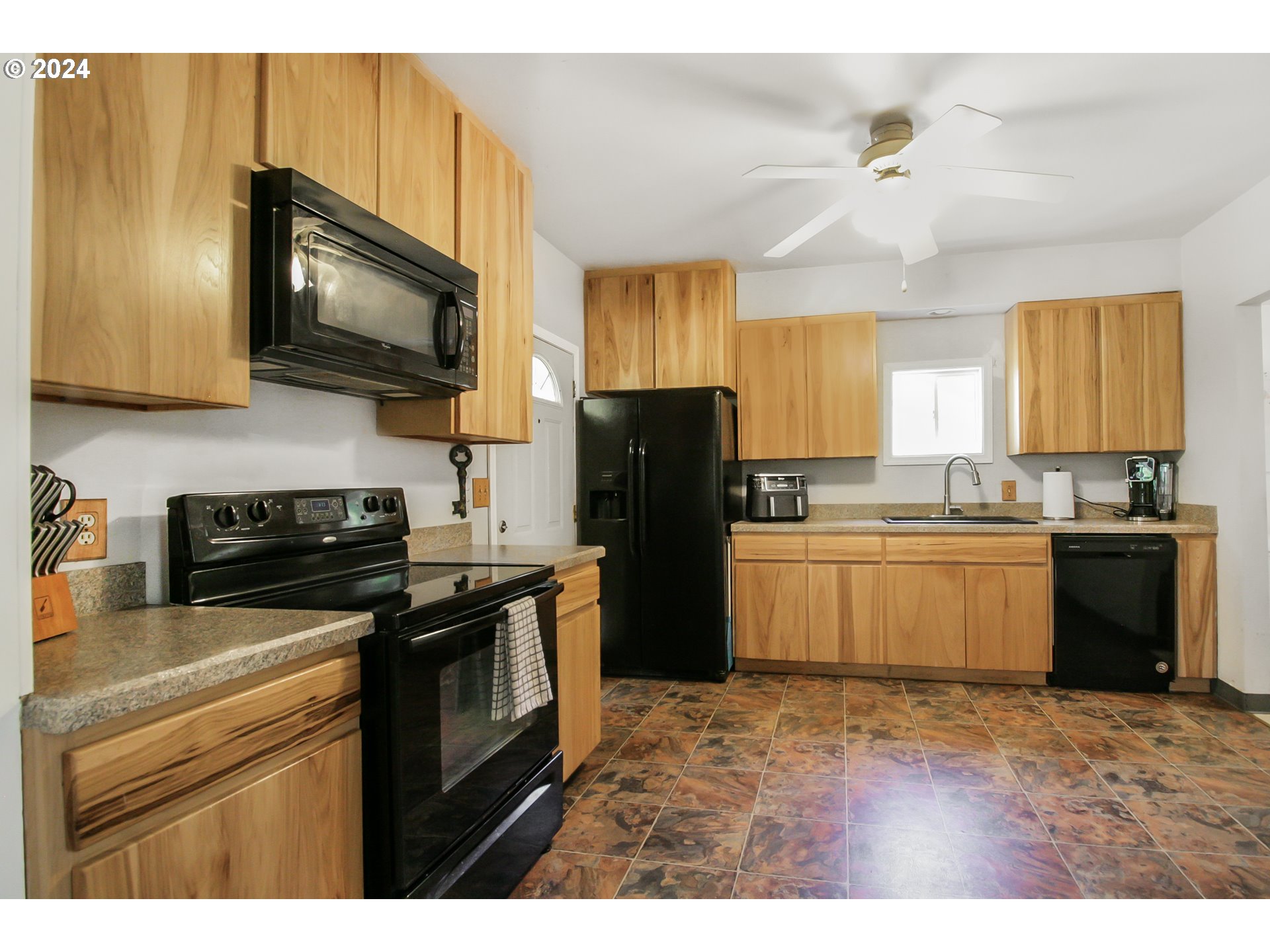 20239 Northwest Pihl Road Banks, OR 97106 - Photo 9 of 35 a kitchen with a sink stainless steel appliances and cabinets