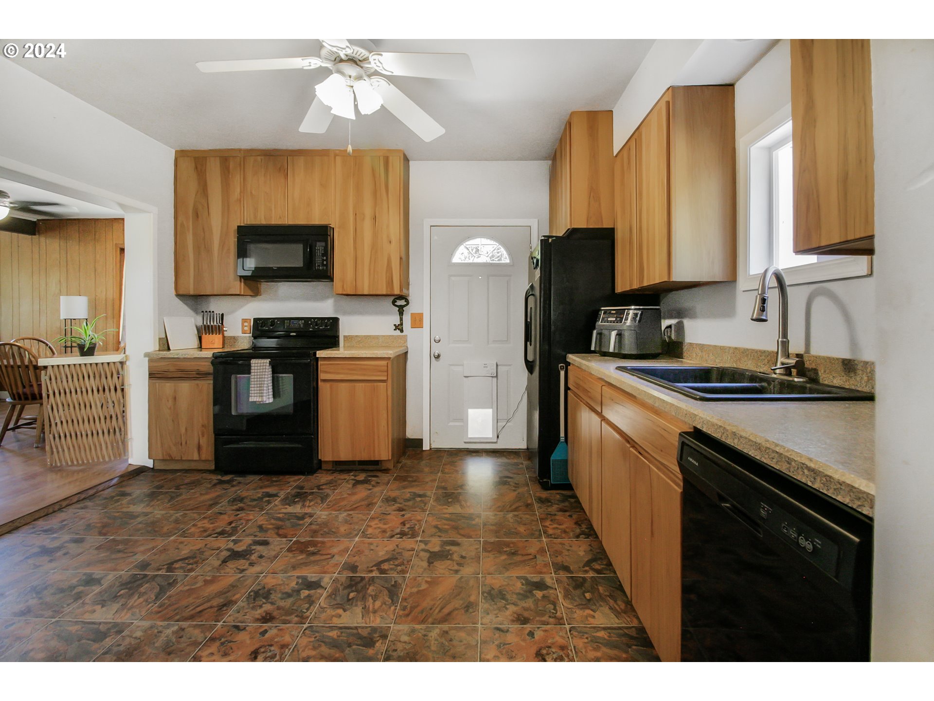 20239 Northwest Pihl Road Banks, OR 97106 - Photo 10 of 35 a kitchen with a sink cabinets and stainless steel appliances