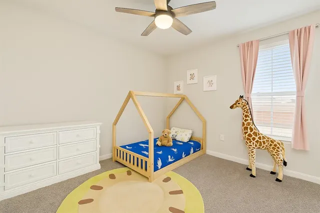 a bedroom with furniture and a window