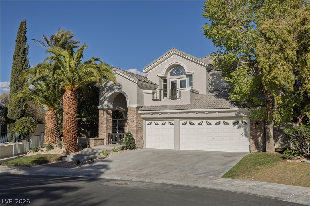 8800 Lusso Las Vegas, NV 89134 - Photo 15 of 85 View of front of property with stucco siding, french doors, driveway, and brick siding