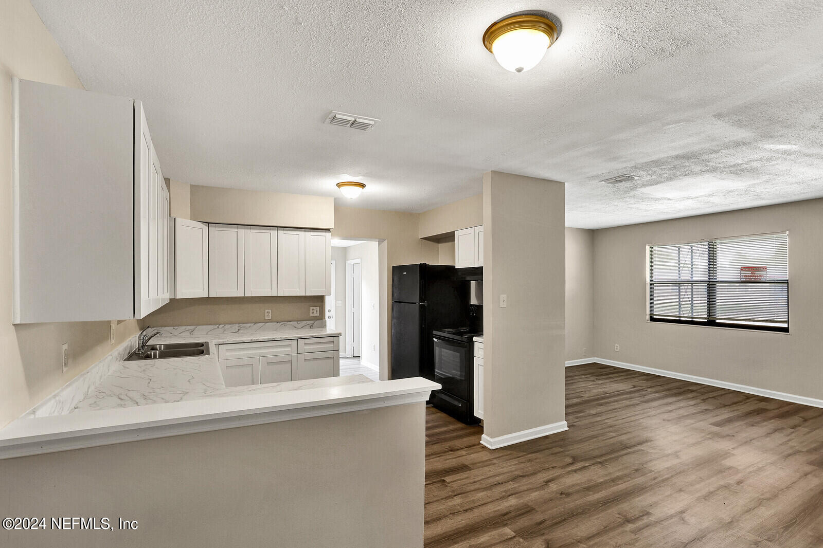 4503 Barnes Road South Jacksonville, FL 32207 - Photo 6 of 24 a kitchen with stainless steel appliances granite countertop a refrigerator a sink a stove and a refrigerator