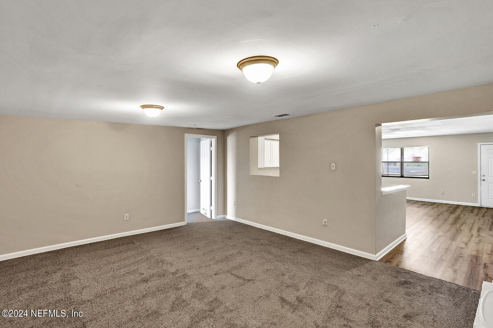 4503 Barnes Road South Jacksonville, FL 32207 - Photo 9 of 24 a view of an empty room with a window