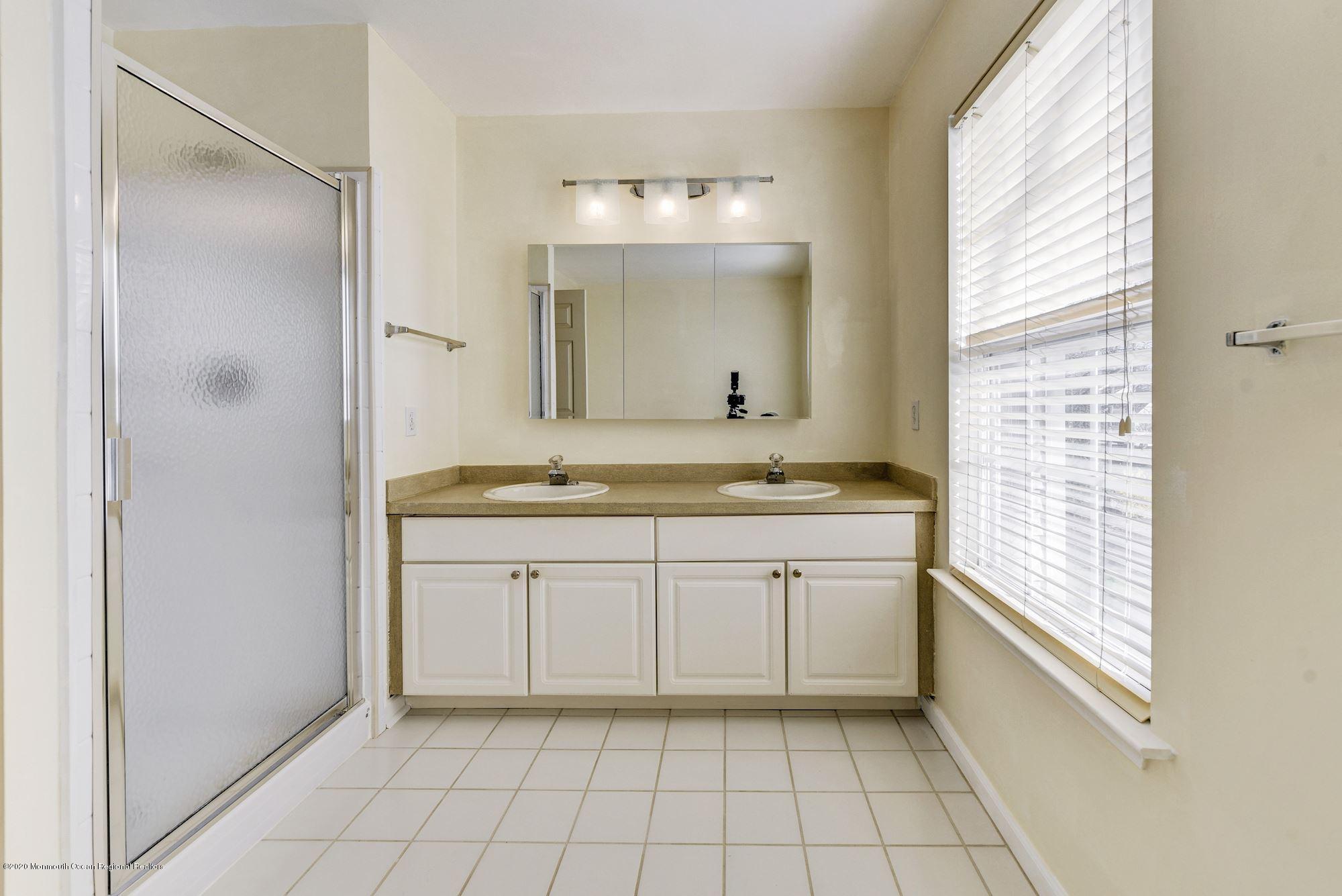 934 Hyson Road Jackson, NJ 08527 - Photo 25 of 43 a bathroom with a granite countertop sink mirror and a