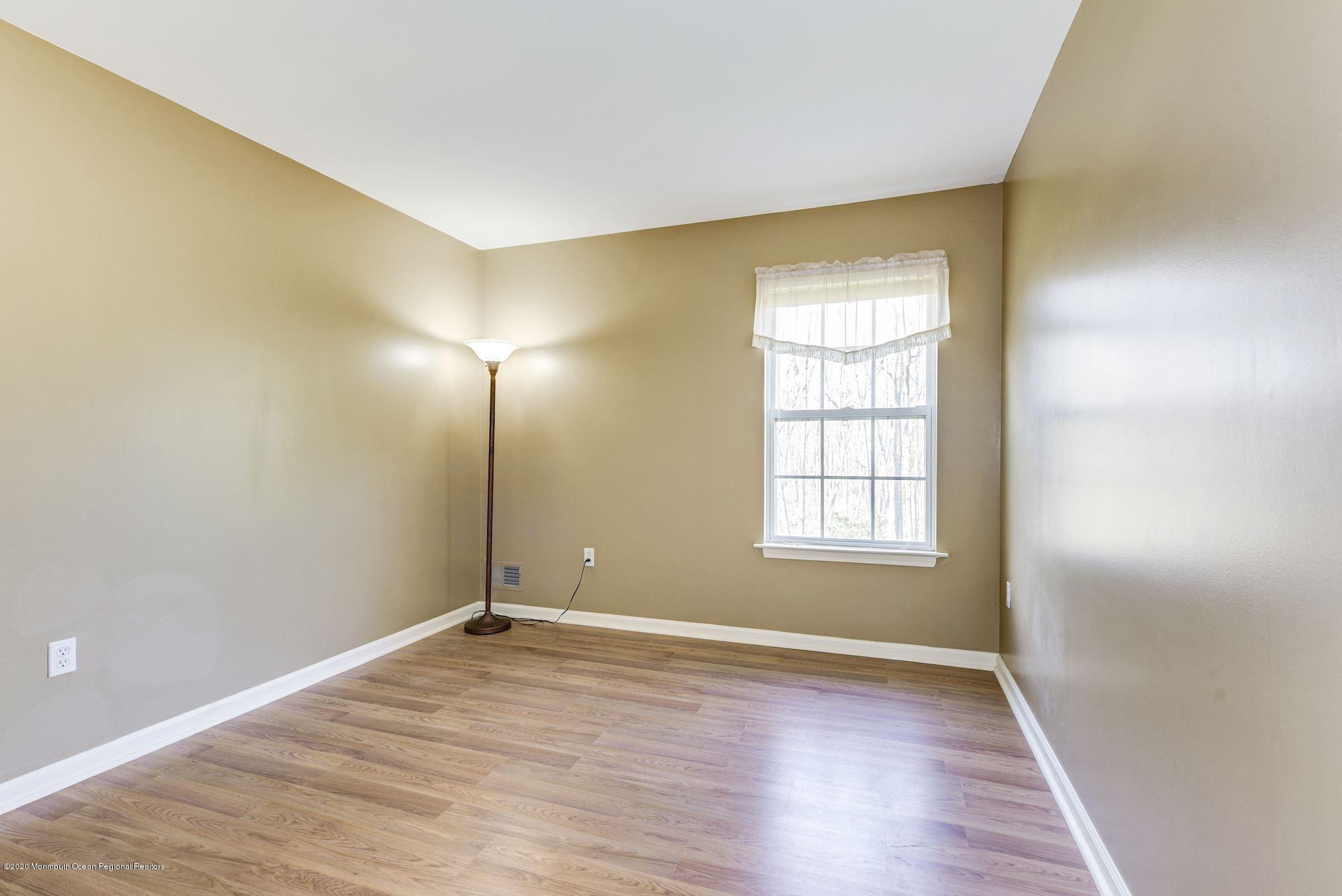 934 Hyson Road Jackson, NJ 08527 - Photo 27 of 43 an empty room with wooden floor and windows