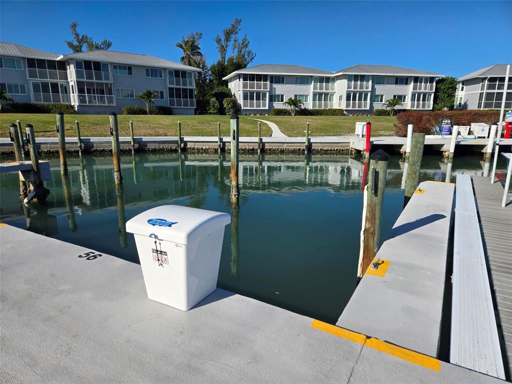 5820 Gasparilla Road, Unit SLIP 56 Boca Grande, FL 33921 - Photo 4 of 10 a roof deck with a table and chairs