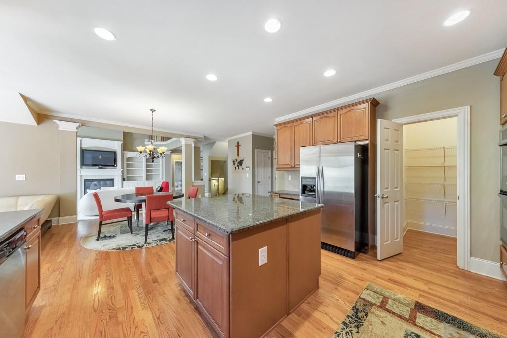 3161 Willowstone Drive Duluth, GA 30096 - Photo 24 of 72 a kitchen with stainless steel appliances granite countertop a refrigerator a stove and a wooden floors