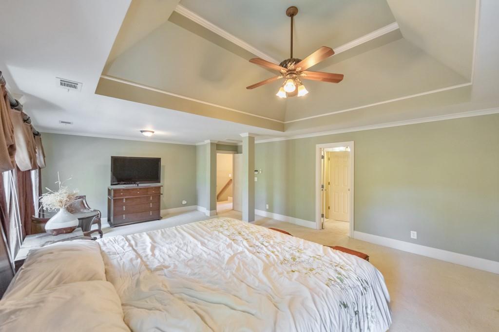 3161 Willowstone Drive Duluth, GA 30096 - Photo 30 of 72 a spacious bedroom with a bed and a flat screen tv
