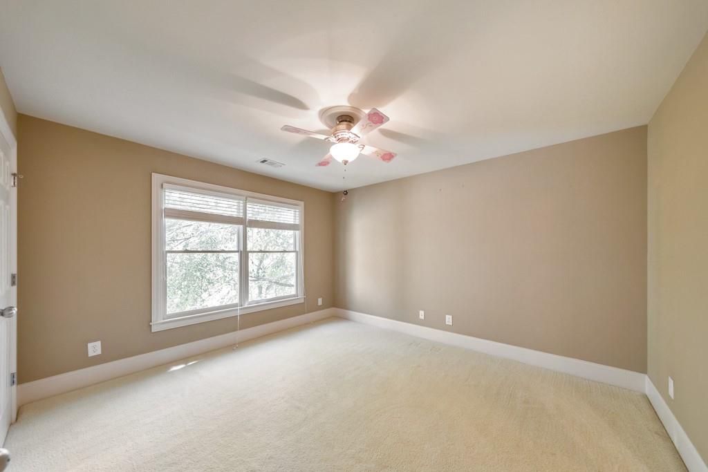 3161 Willowstone Drive Duluth, GA 30096 - Photo 40 of 72 an empty room with windows and chandelier fan