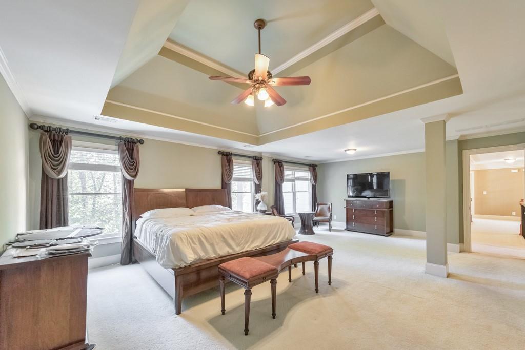 3161 Willowstone Drive Duluth, GA 30096 - Photo 4 of 72 a bedroom with a large bed couch and windows