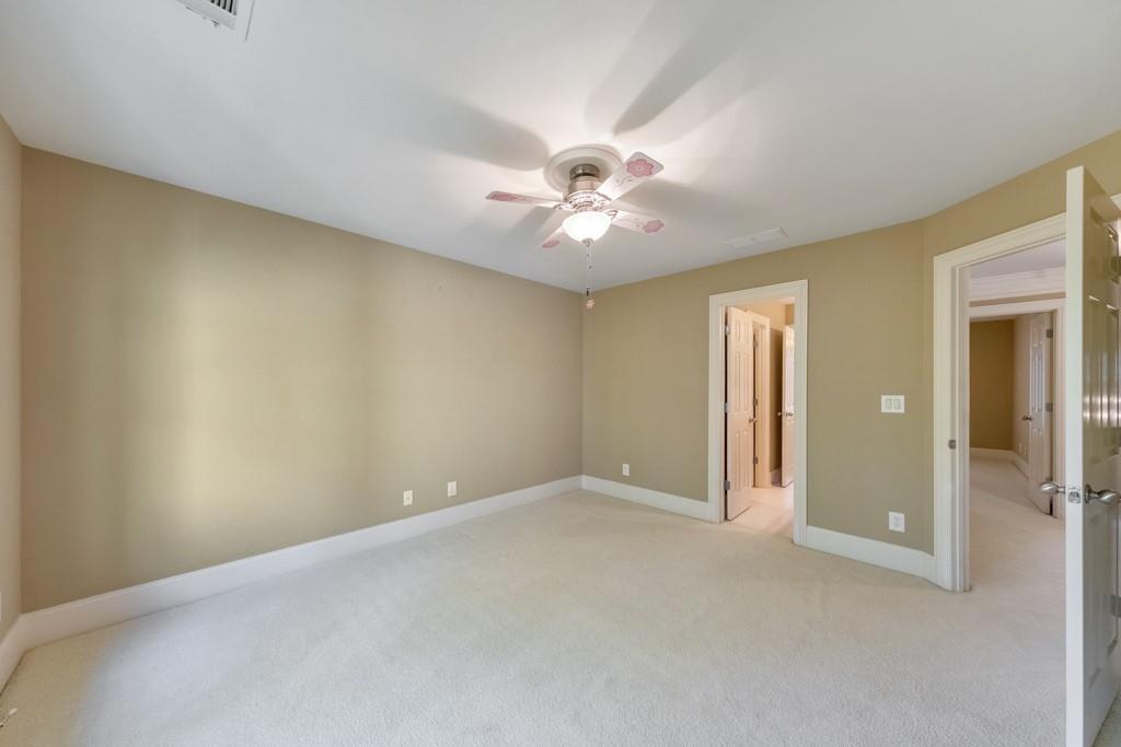 3161 Willowstone Drive Duluth, GA 30096 - Photo 41 of 72 an empty room with a ceiling fan and a window