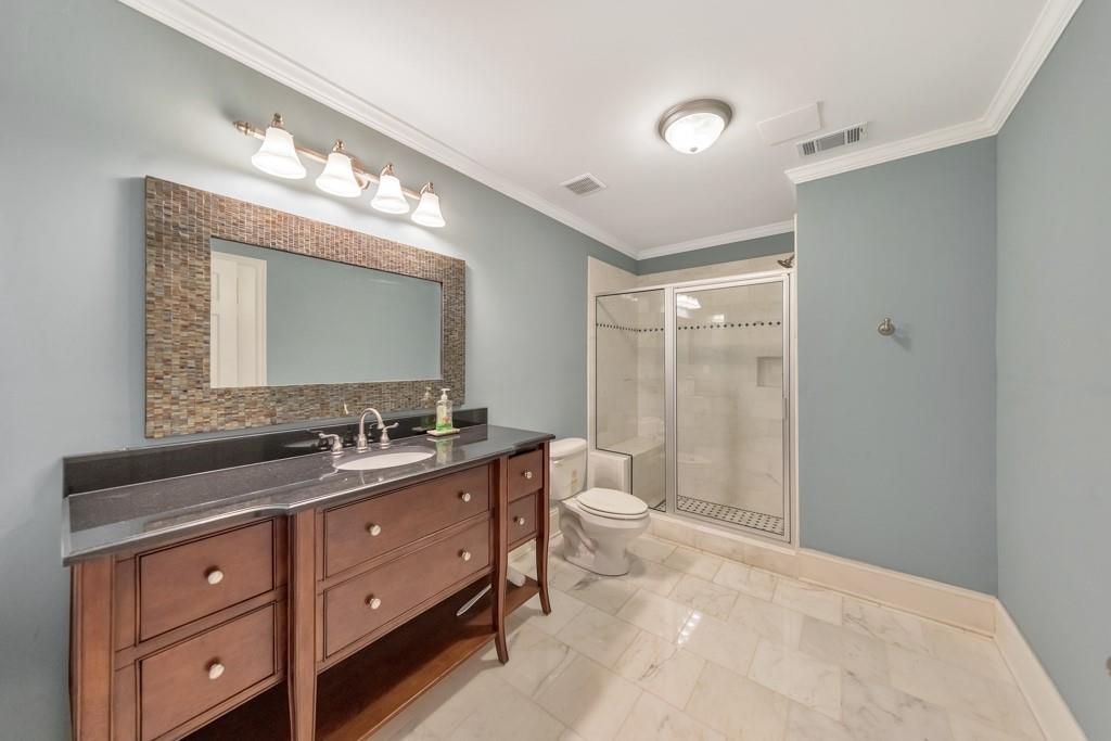 3161 Willowstone Drive Duluth, GA 30096 - Photo 58 of 72 a bathroom with a toilet sink double vanity and mirror