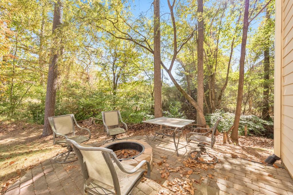 3161 Willowstone Drive Duluth, GA 30096 - Photo 63 of 72 a view of a patio with table and chairs with wooden fence and floor