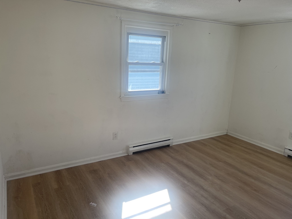 5 Tower Street Methuen, MA 01844 - Photo 4 of 9 an empty room with wooden floor and windows