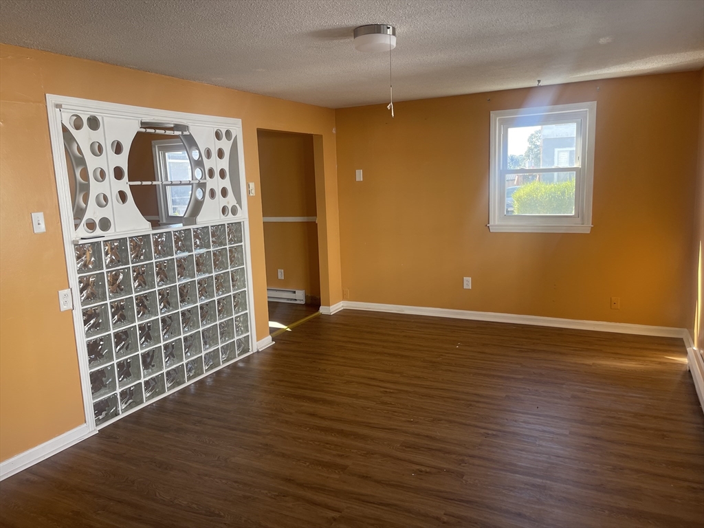 5 Tower Street Methuen, MA 01844 - Photo 5 of 9 a view of an empty room with wooden floor and a window