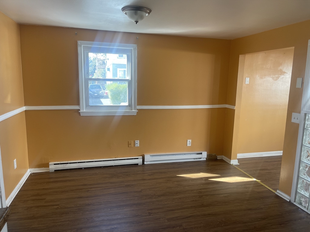5 Tower Street Methuen, MA 01844 - Photo 7 of 9 an empty room with wooden floor and windows