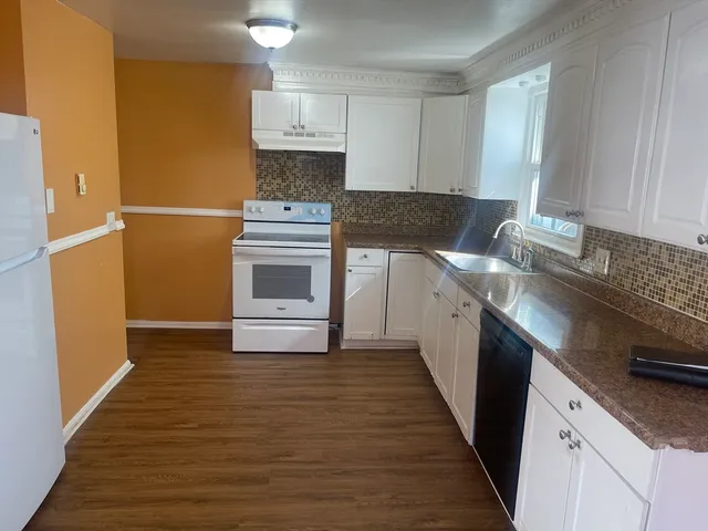 a kitchen with a sink stove and cabinets