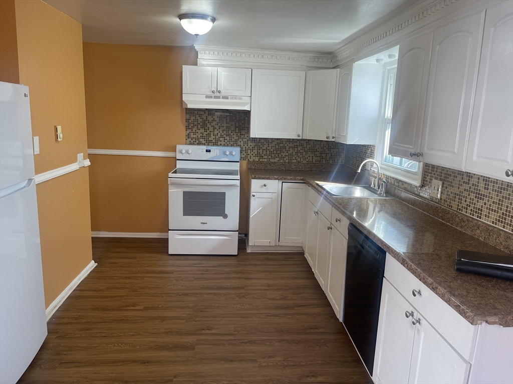 5 Tower Street Methuen, MA 01844 - Photo 8 of 9 a kitchen with a sink stove and cabinets
