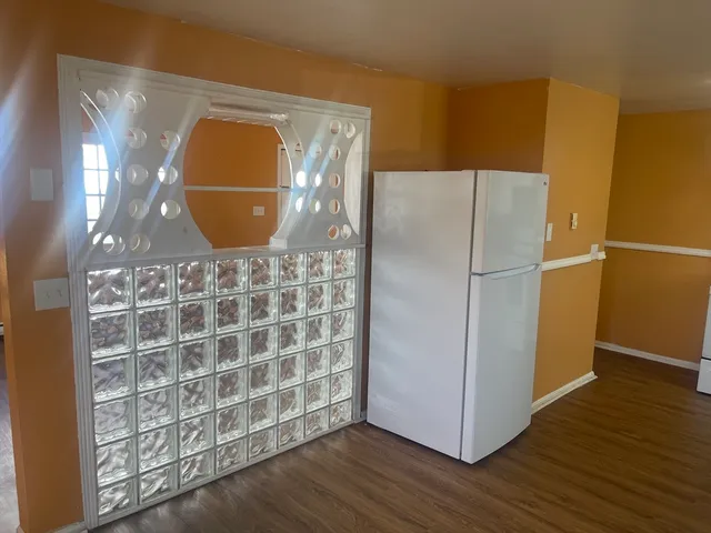 a view of a refrigerator in wooden floor