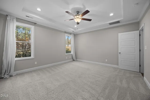 an empty room with closet and ceiling fan