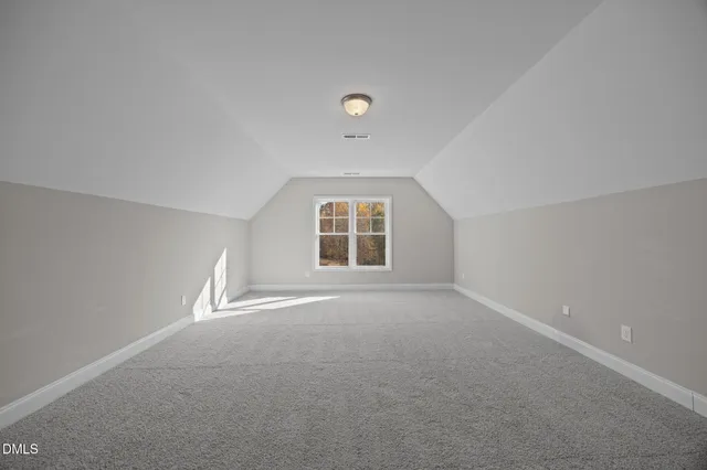 an empty room with windows and ceiling fan