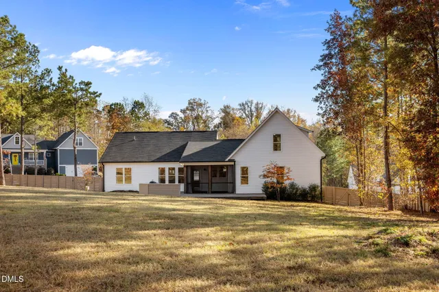 a view of a house with swimming pool and a yard