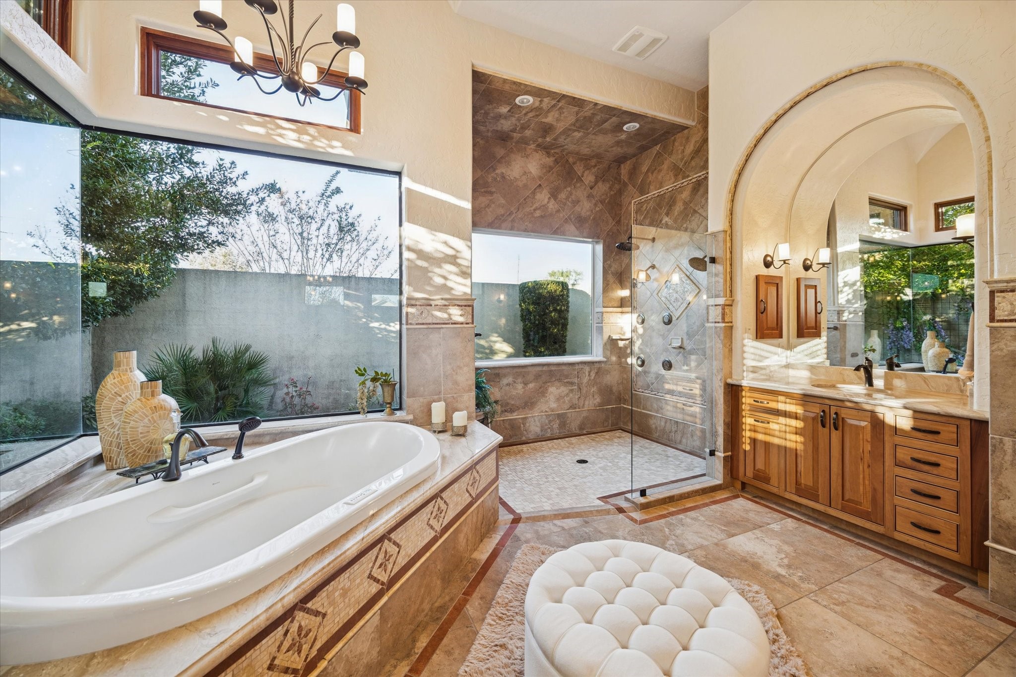 21538 Mueschke Road Tomball, TX 77377 - Photo 23 of 50 Primary en-suite bathroom oasis. Imagine ending your day in this serene retreat, designed to melt away stress and elevate your senses. Dual vanities with ample storage and oversized mirrors provide a personal sanctuary for preparation and self-care. Bathed in natural light, the spa-like layout features a separate shower and an ultra-soaking tub overlooking a private garden, the perfect setting to relax, rejuvenate, and savor peaceful moments in absolute luxury.