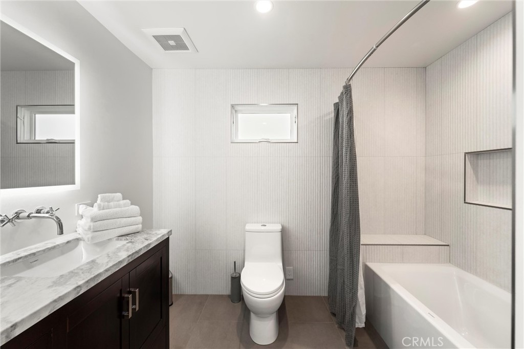 7337 La Soldadera Rancho Santa Fe, CA 92067 - Photo 28 of 60 a bathroom with a granite countertop toilet sink and mirror