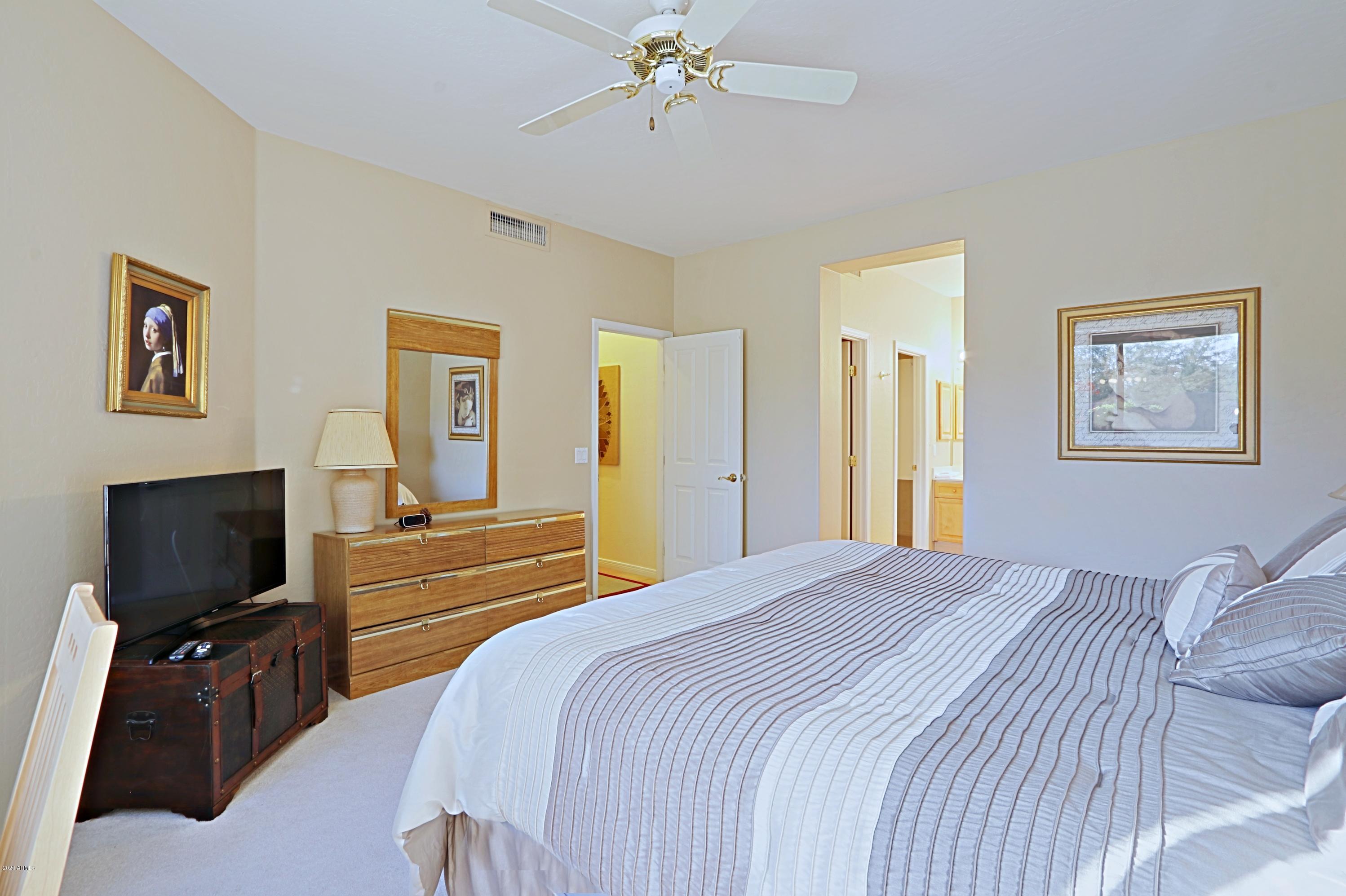 6803 East Eagle Feather Road Scottsdale, AZ 85266 - Photo 14 of 67 a bedroom with a bed and a flat screen tv