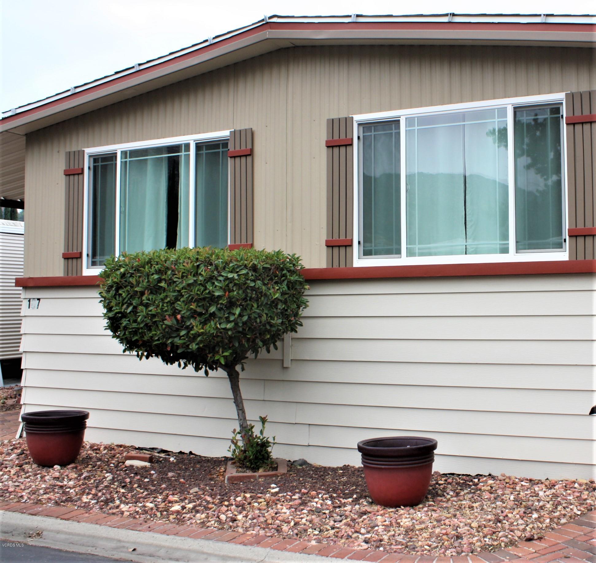 6480 Katherine Road, Unit 107 Simi Valley, CA 93063 - Photo 1 of 22 a potted plant sitting in front of a house