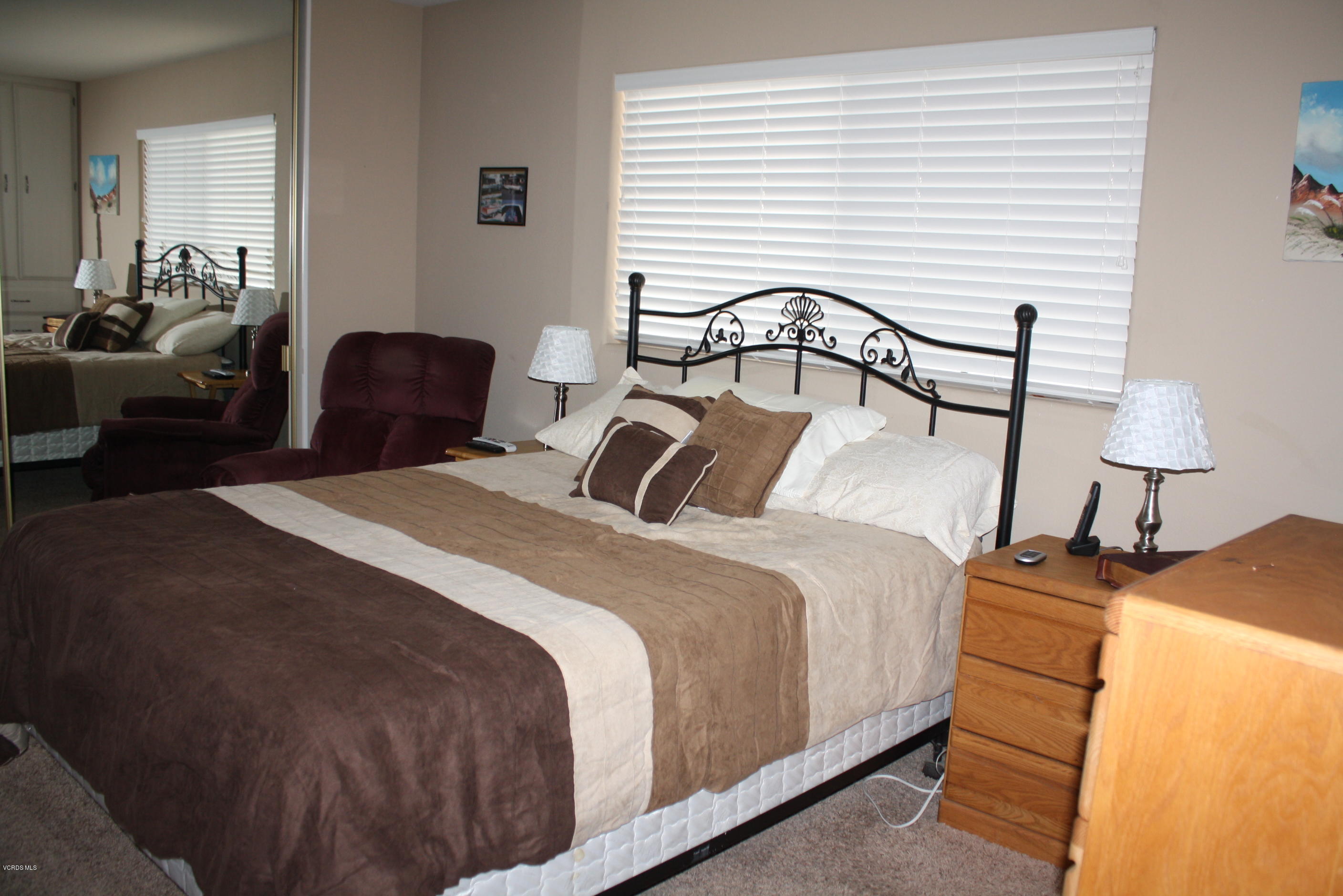 6480 Katherine Road, Unit 107 Simi Valley, CA 93063 - Photo 14 of 22 a bedroom with bed and a lamp on dresser