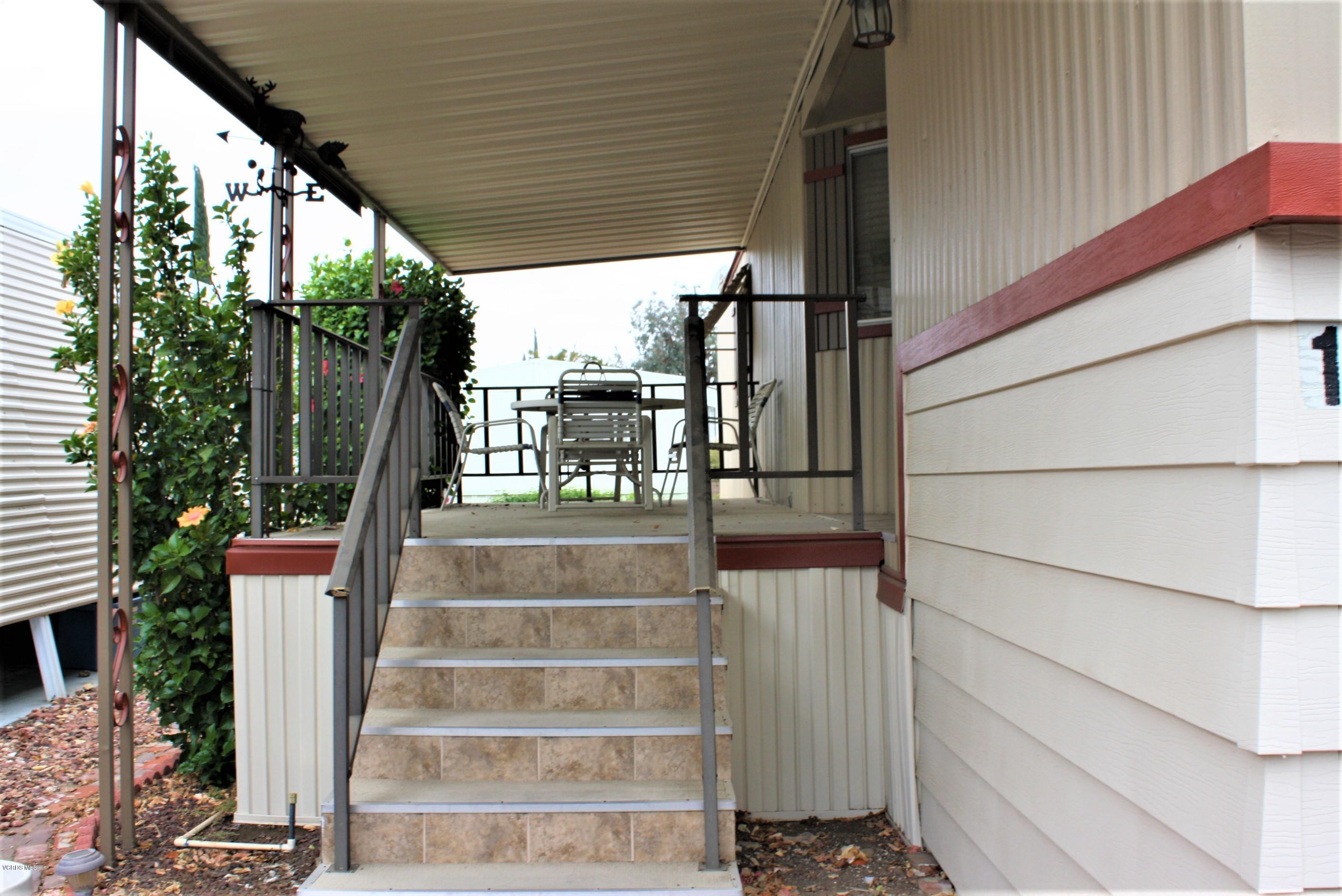 6480 Katherine Road, Unit 107 Simi Valley, CA 93063 - Photo 5 of 22 a view of staircase with white walls and windows