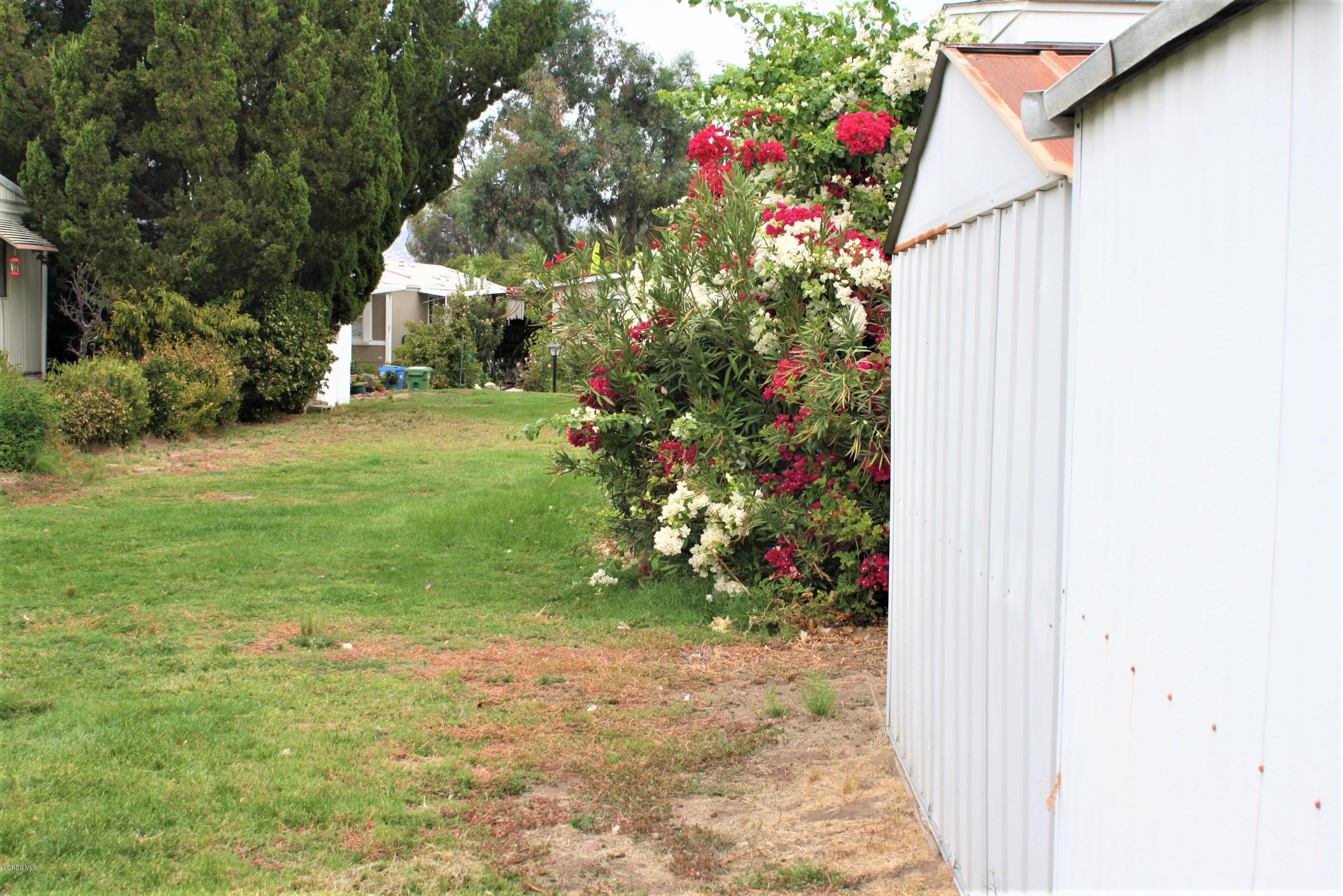 6480 Katherine Road, Unit 107 Simi Valley, CA 93063 - Photo 8 of 22 a flower garden in front of a house