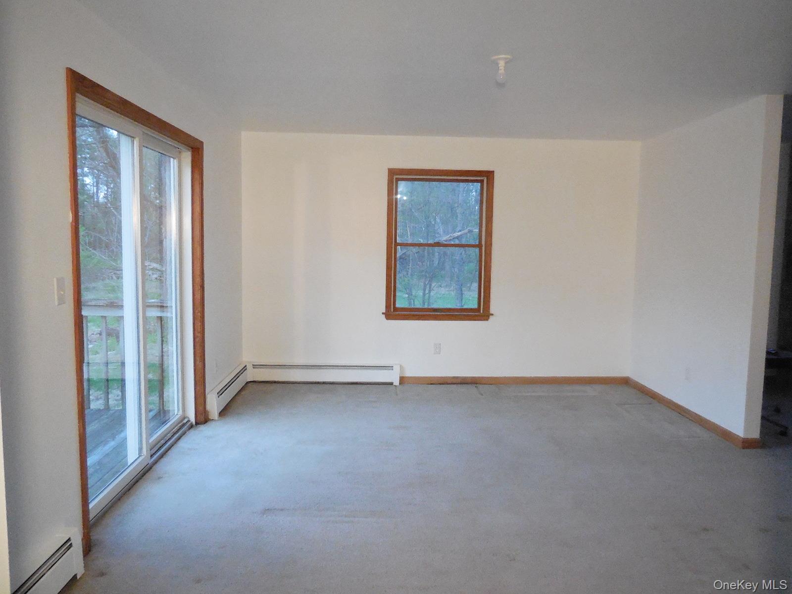 617 Burlingham Road Bloomingburg, NY 12721 - Photo 5 of 39 Dining room with patio sliders leading to rear deck overlooking private back yard.