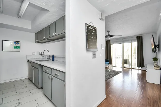 a kitchen with stainless steel appliances granite countertop a sink stove and wooden cabinets
