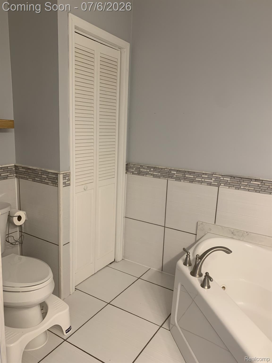 4168 Harris Road Fort Gratiot, MI 48059 - Photo 26 of 30 White tile flooring and a corner soaking tub with brushed nickel fixtures