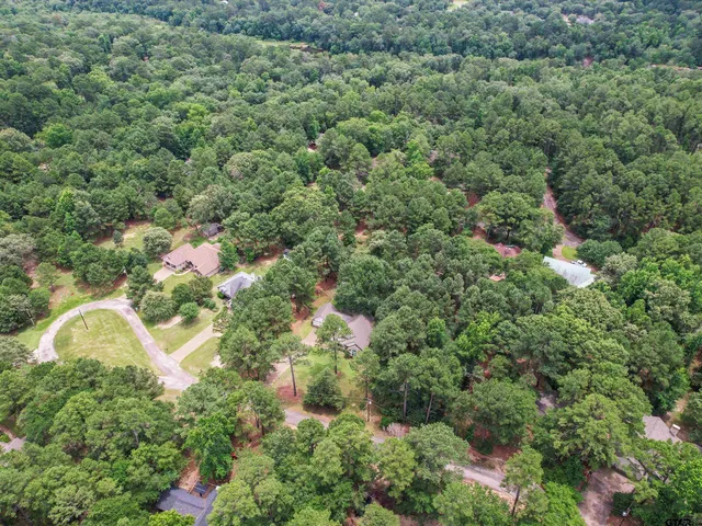 an aerial view of a residential houses with yard and outdoor seating