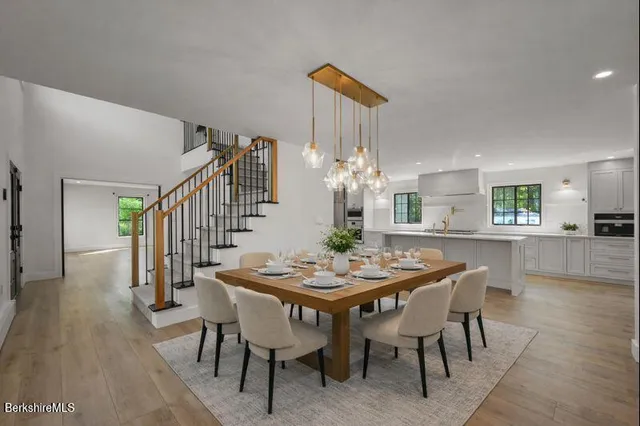 a open kitchen with stainless steel appliances granite countertop a stove and a large window