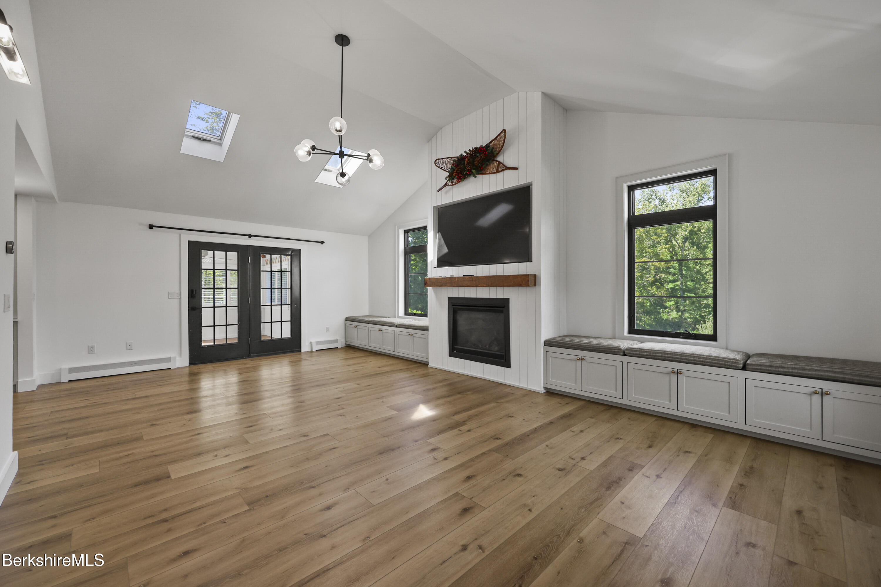 65 Johnson Road Dalton, MA 01226 - Photo 21 of 76 an empty room with windows fireplace and wooden floor
