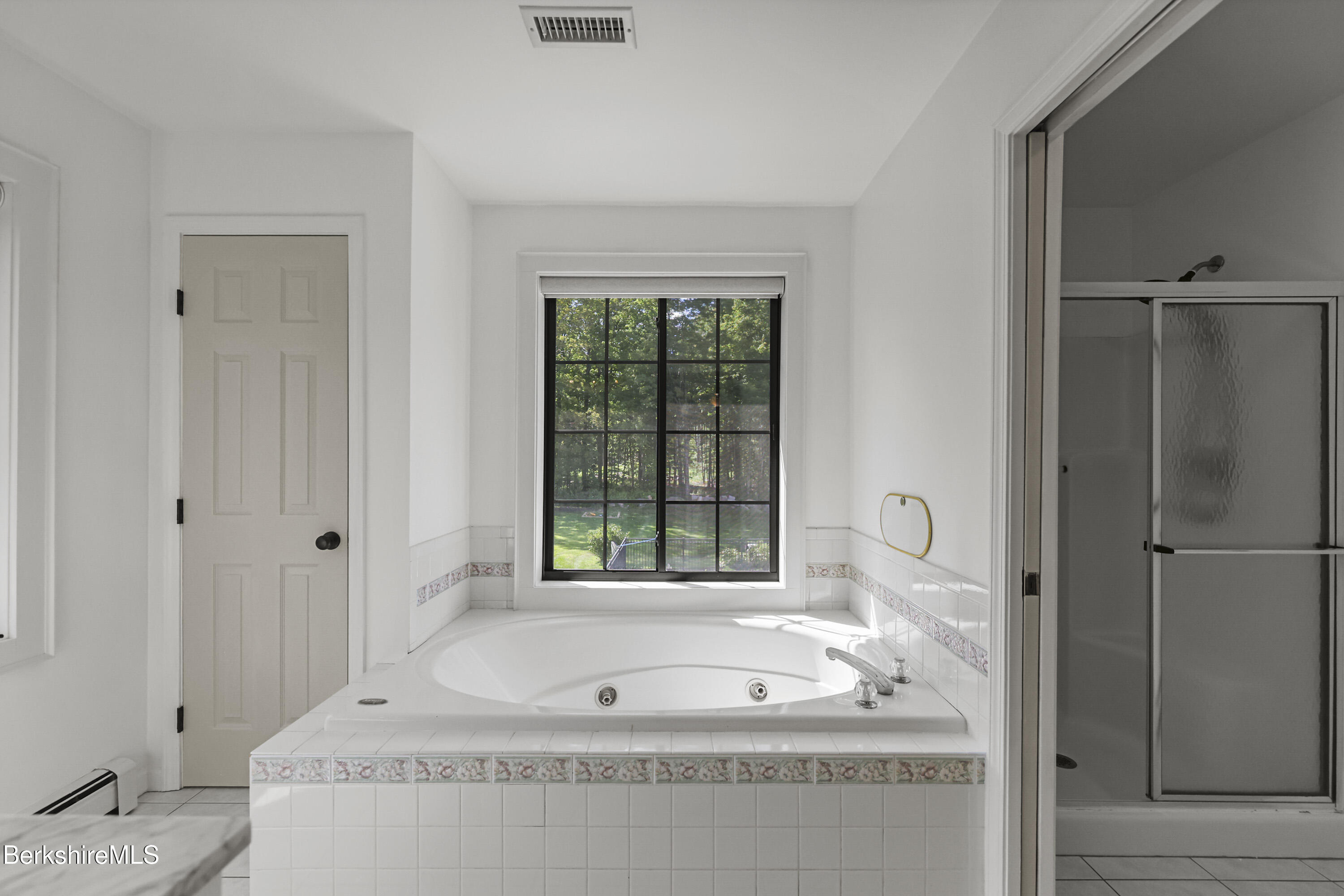 65 Johnson Road Dalton, MA 01226 - Photo 34 of 76 a bathroom with a tub a sink and a window